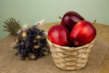 Red beautiful apples in a basket on the table. Red apples. Apple diet. High quality photoの写真素材