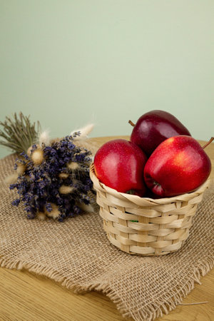 Red beautiful apples in a basket on the table. Red apples. Apple diet. High quality photoの写真素材