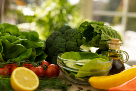 Red tomatoes, lettuce leaves on the table close-up. Vegetables for salad on the kitchen table. High quality photoの写真素材