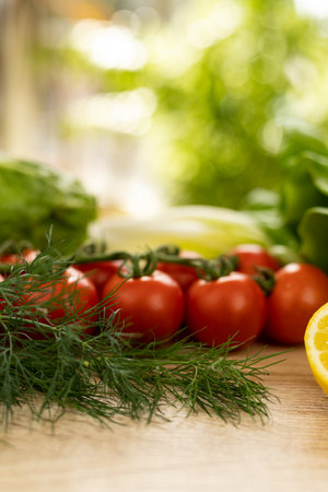 Red tomatoes, lettuce leaves on the table close-up. Vegetables for salad on the kitchen table. High quality photoの写真素材