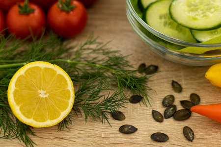 Red tomatoes, lettuce leaves on the table close-up. Vegetables for salad on the kitchen table. High quality photoの写真素材