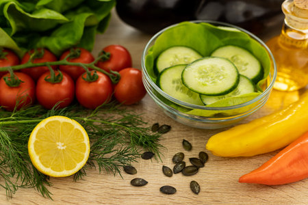 Red tomatoes, lettuce leaves on the table close-up. Vegetables for salad on the kitchen table. High quality photoの写真素材