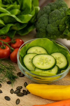 Paprika, chopped cucumbers on the table. The process of preparing a salad. Healthy eating. Diet. High quality photoの写真素材