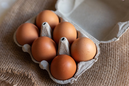 Chicken eggs in an egg carton. Homemade chicken eggs close-up. High quality photoの写真素材