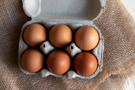 Chicken eggs in an egg carton. Homemade chicken eggs close-up. High quality photoの写真素材