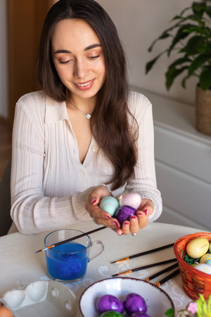 Beautiful young woman holding easter eggs in her hands. Preparing for Easter. High quality photoの写真素材