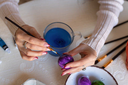 Female hands with easter eggs top view. Decorating Easter eggs. High quality photoの写真素材