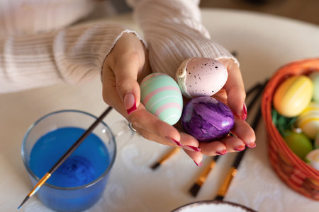 Female hands with easter eggs top view. Decorating Easter eggs. High quality photoの写真素材