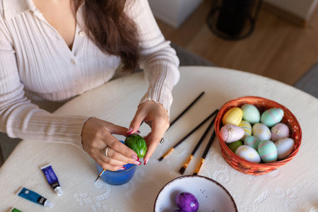 Female hands with easter eggs top view. Decorating Easter eggs. High quality photoの写真素材