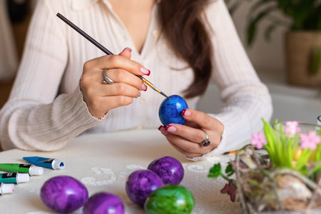Female hands with Easter eggs with a large palan. Dyeing Easter eggs at home. High quality photoの写真素材