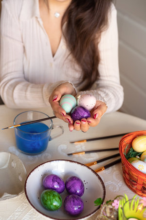 Female hands with easter eggs top view. Decorating Easter eggs. High quality photoの写真素材