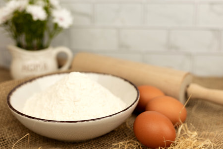Baking products - flour, eggs. Flour and eggs on the table close-up. High quality photoの写真素材