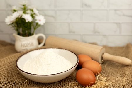 Baking products - flour, eggs. Flour and eggs on the table close-up. High quality photoの写真素材