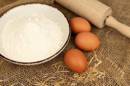 Eggs, flour and rolling pin. Homemade pastries. Dough Ingredients. High quality photoの写真素材