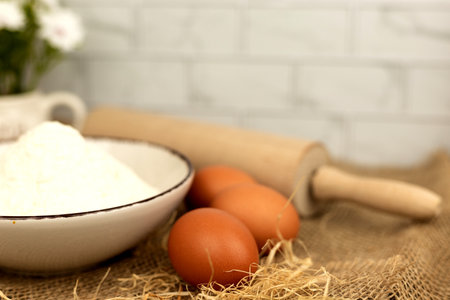 Baking products - flour, eggs. Flour and eggs on the table close-up. High quality photoの写真素材