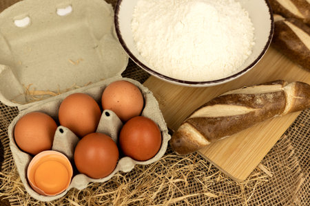 Freshly baked bread, flour, eggs. The process of baking bread. Baking Ingredients. High quality photoの写真素材