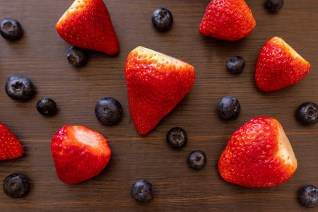 Berries in a plate. Berries on a wooden background. Strawberries and blueberries. Top view. High quality photoの写真素材