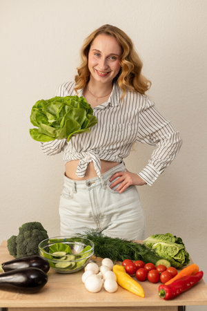 A woman with lettuce. Athletic slim girl with vegetables. High quality photoの写真素材