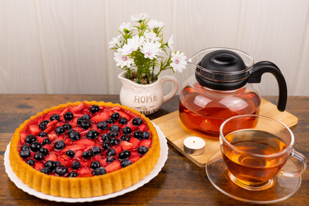 Berry pie and tea on the table. Dessert for tea. Berry pie. Strawberry pie on the table. High quality photoの写真素材