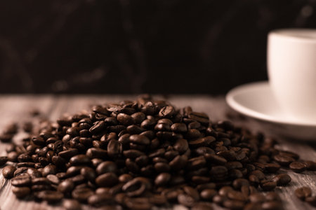 Cup of coffee and coffee beans on a brown background. Black strong coffee. High quality photoの写真素材