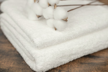 Cotton flowers on a white towel. White terry cloth. Natural cotton. High quality photoの写真素材