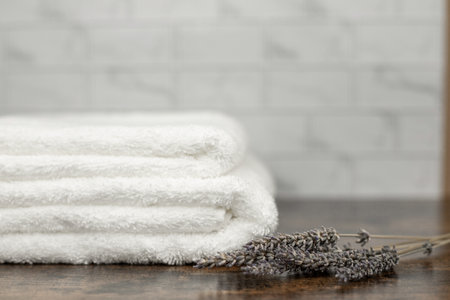 White terry towels on a wooden background. Dried lavender flowers. High quality photoの写真素材