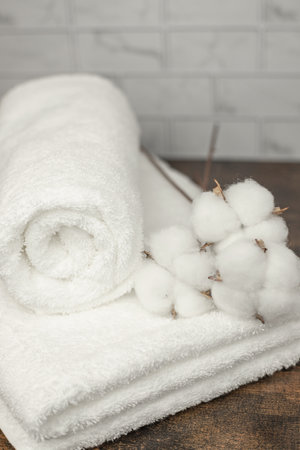 White towels in the bathroom. Dried cotton flowers next to towels. High quality photoの写真素材