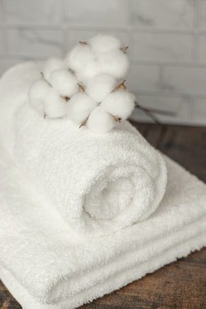 Beautiful white terry towels. Beautifully folded towels. White Cotton Flowers. High quality photoの写真素材