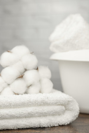 A white terry towel, a basin and cotton. Cotton flowers. High quality photoの写真素材