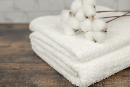 Cotton flowers lie on towels. Freshly washed towels. Home textiles. High quality photoの写真素材