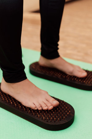 A woman stands on a Sadhu board. therapy. Emotional state of a woman. High quality photoの写真素材
