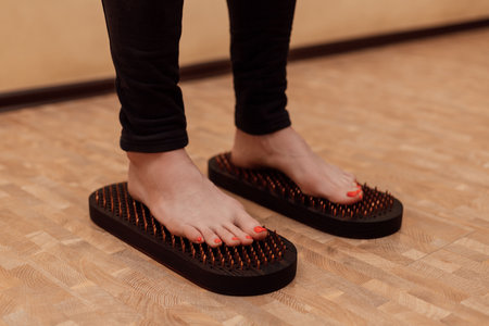 Women's feet on nails. A woman's legs. Sadhu Board Therapy. High quality photoの写真素材
