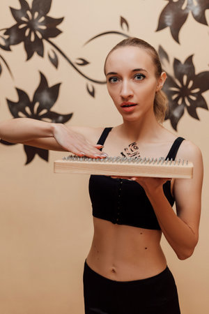A woman holds a sadhu board in her hands. High quality photoの写真素材