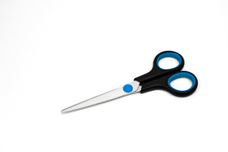 Blue Plastic Scissors Isolated on White Background. Top View of Closed Scissors. School or office. Copy Space for Text or Image. High quality photoの写真素材