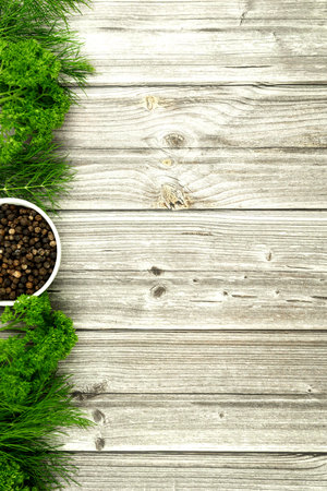 Dill, parsley and black peppercorns on a wooden background. Spices on the table. Banner for a cooking recipe. High quality photoの写真素材