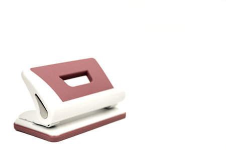 A device for piercing holes in paper. Office accessory on a white backgroundの写真素材