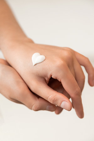 Close-up of womens hands. hand cream. like a heart. the concept of skin care, hydrationの写真素材