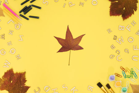 Background on the topic of education, school background. Alarm clock on a yellow background top view. High quality photoの写真素材