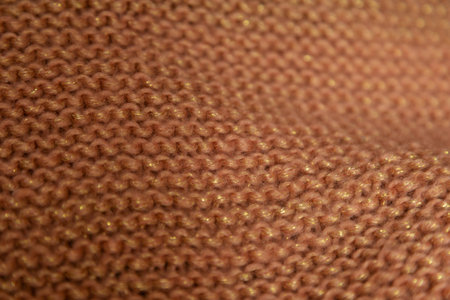 Texture of a knitted sweater close-up. Brown knitted fabric. High quality photoの写真素材