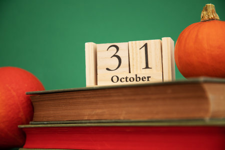 Wooden calendar of October 31 on books close-up. Orange Squalls and Booksの写真素材