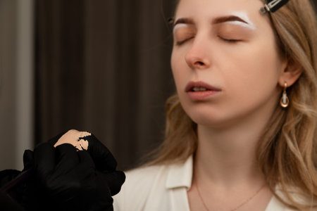 Makeup Artist Applying Cosmetic Product on Female Face. High quality photo