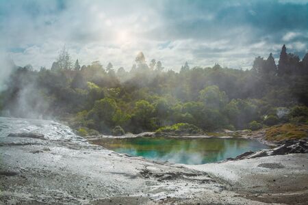 Moody landscape with steam rising pool in a geothermal zone in the mountains. Rotorua, New Zealandの写真素材