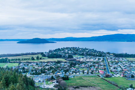 Aerial view of Rotorua city in the dusk. City centre by the lake Rotorua and distant mountains....