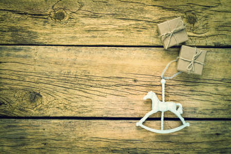 Vintage photo with old rocking horse ornament and gift boxes.の写真素材