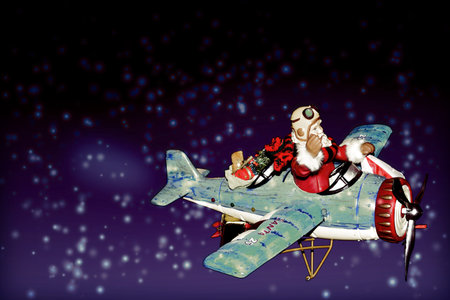 Santa Claus delivering presents in a blue airplane on a snowy night.