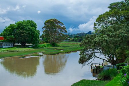 Picturesque summer landscape with a calm river lazily flowing between green riverbank. Peaceful...