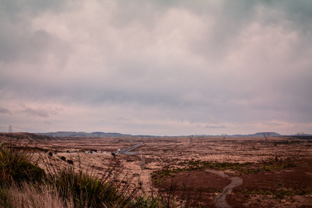 Retro style photo of a Volcanic Loop Hwy winding through vast and empty land. Desert Road, Central...
