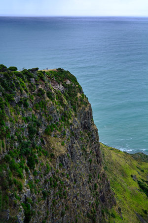 Narrow promontory rising high above over calm blue waters of Tasman Sea. Te Toto Gorge Lookout,...