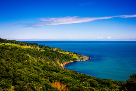 Panoramic view over high coast of Tasman Sea on an overcast summer day. High vantage point. Raglan,...