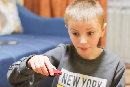 Happy child 6-8 years playing with cars and toys at home, indoor.の写真素材